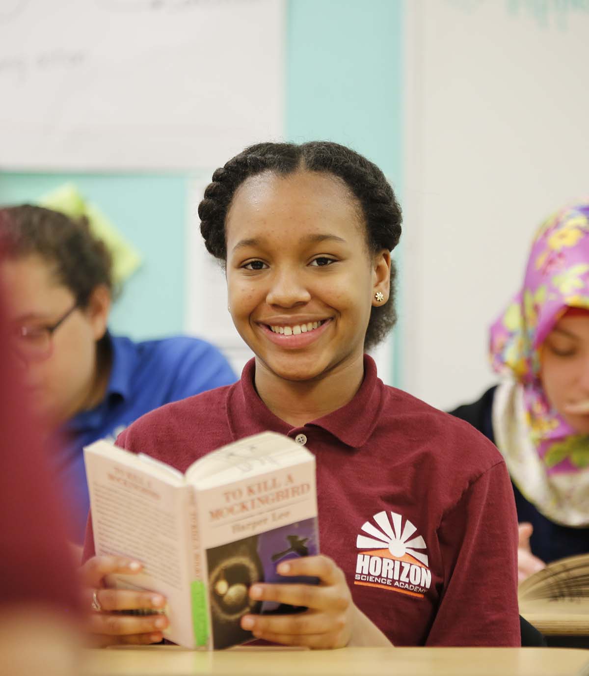 Horizon Science Academy Toledo student wearing headphones uses a laptop in class