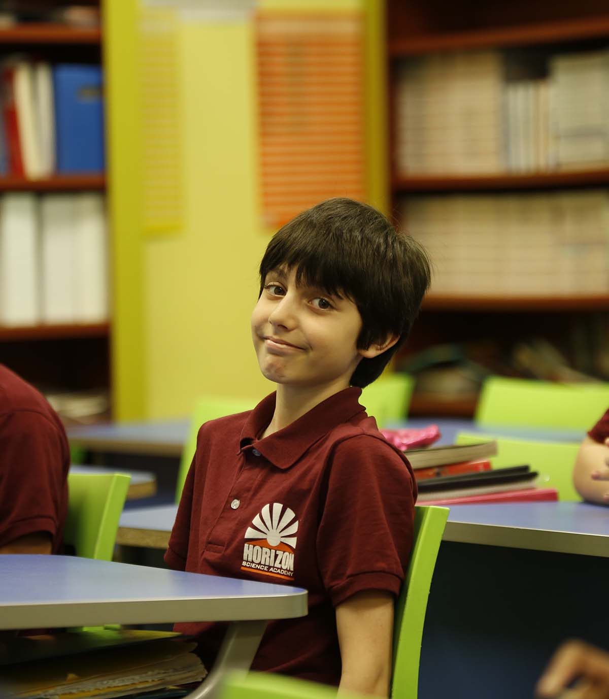 Horizon Science Academy Toledo student drawing at a desk in a classroom setting